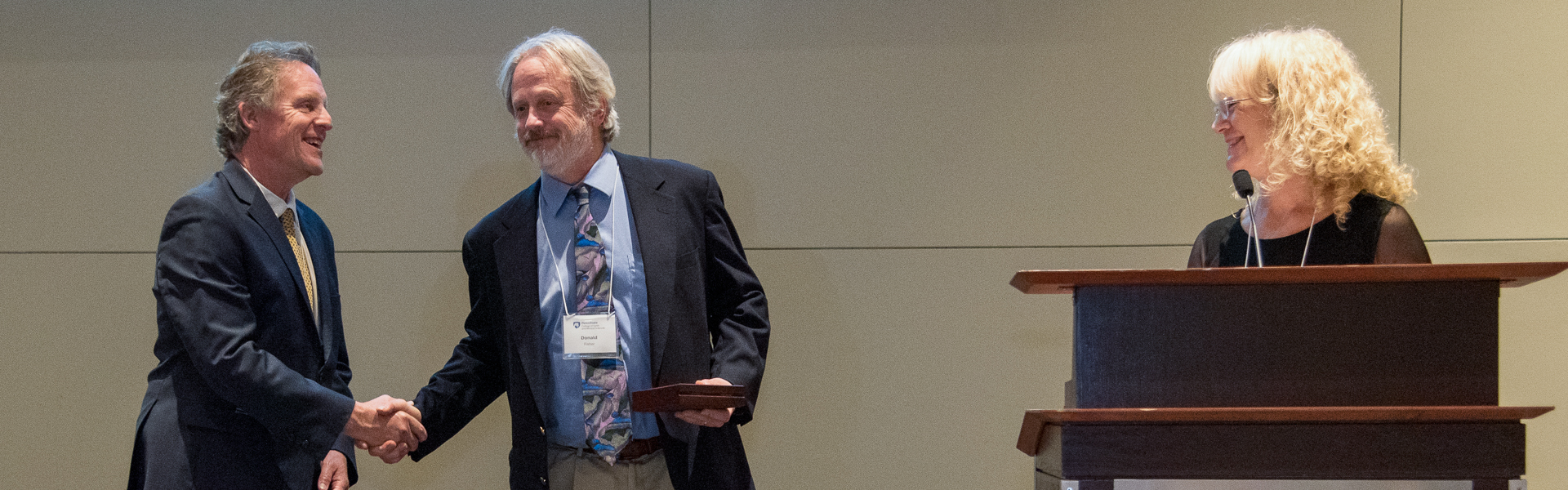 Don Fisher laughing while accepting his award from Dean Kump
