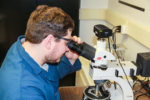 Penn State student Nathan Gendrue reviews the characterization of coal dust under a high-resolution microscope