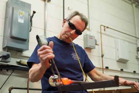 Distinguished Professor of Materials Science and Engineering Carlo Pantano shapes glass at his glass blowing studio in the Hosler Building. Pantano, who has dedicated almost 40 years to studying the surface of glass, retires June 30.