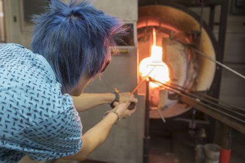 Briana Bennett heats glass in Penn State's fully-equipped glassblowing shop.