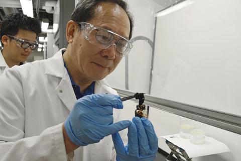 Michael Chung, professor of materials science at Penn State, holds a solid chunk of oil that is able to be reused. 