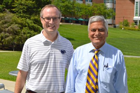 John Mauro, a glass expert and professor at Penn State, stands with his undergraduate adviser Arun Varshneya 