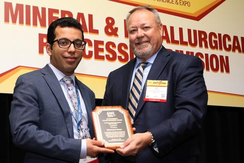  Mohammad Rezaee, left, received the Outstanding Young Engineer Award from the Society for Mining, Metallurgy & Exploration