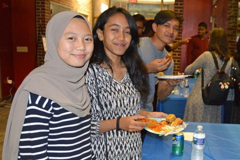 Students sampling food at the College of Earth and Mineral Sciences International Culture Night.