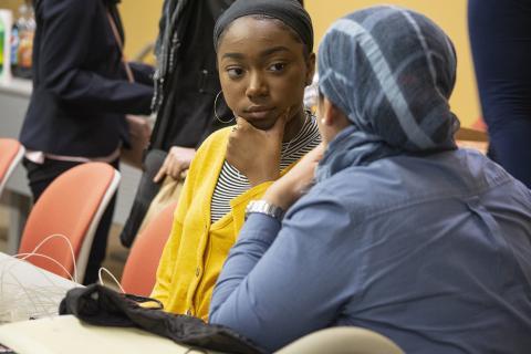 Faculty mentor Ola Rashwan, speaks with high school student Zimirah Wilson (left), at an EnvironMentors meeting