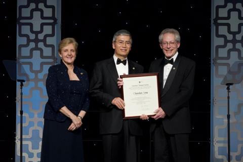 George A Olah Award recipient Chunshan Song (center) is presented his award by John Adams (right) and  Bonnie A. Charpentier