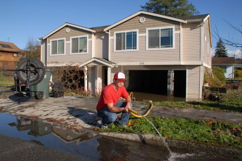 Sultan, Washington, Nov. 11, 2006 — Mitch McKron pumps water from the basement 