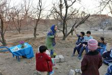 Geography graduate student Elham Nasr Azadani tells a story to students at the nature school about “Yalda Night.”