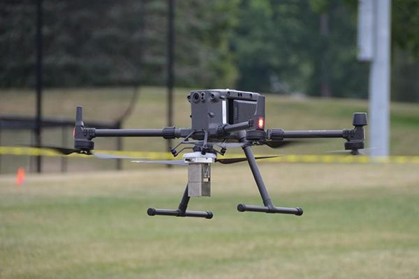 A drone used to detect radiation hovers near the tennis courts at the intermural fields on West Campus at University Park