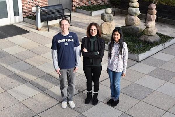 Ezgi Toraman outside the Steidle Building with her graduate students Sean Okonsky, left, and Antara Bhowmick, right.