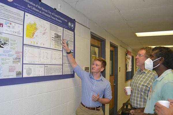 Aiden Thomas, REU participant, explains his research to Andrew Nyblade and Sridhar Anandakrishnan