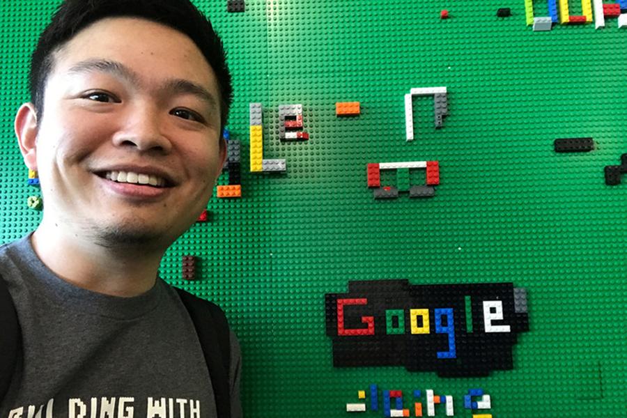 Geography doctoral student Xi Liu stands next to a Lego display in Google's Seattle offices. 
