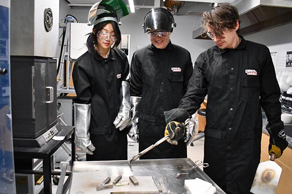 ulia Chen, left, with John Mauro, center, and Nick Clark, a postdoctoral fellow, work with LionGlass in the glass lab