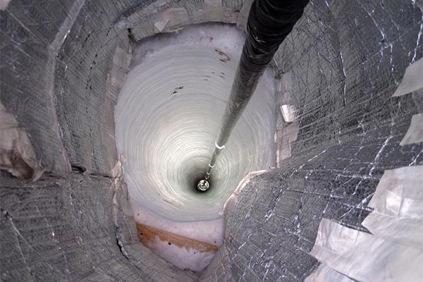 Sensor descends down a hole in the ice as part of the installation of the IceCube telescope.