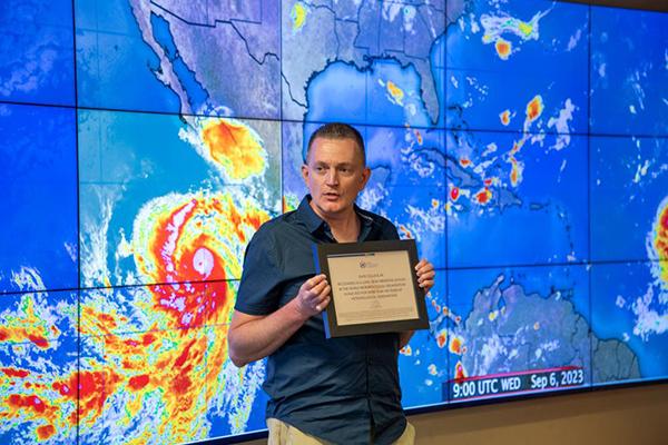 Chris Stachelski of the National Weather Service presents the award 