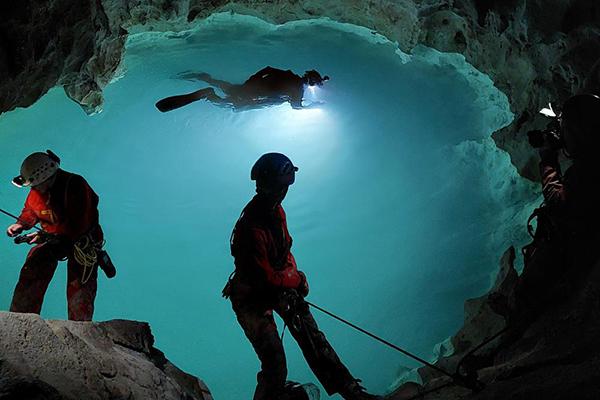 National Geographic photographer Carsten Peter takes a photograph as diver and National Geographic explorer Kenny Broad