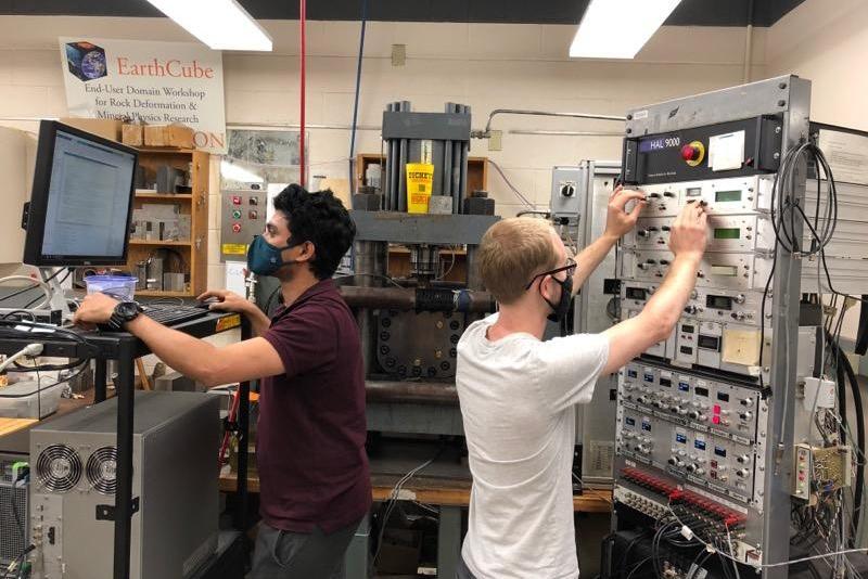 Clay Wood (right), doctoral candidate in geosciences, helps run a series of tests on fractured rock using acoustic vibrations