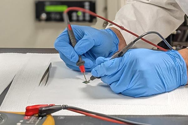 Furkan Turker, graduate student in the Department of Materials Sciences, works on a silicon carbide chip in the laboratory