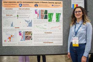 Cristina Elena Mihalache presents her research poster at the American Association of Geographers annual meeting on Wednesday, March 26, in Detroit, Michigan.