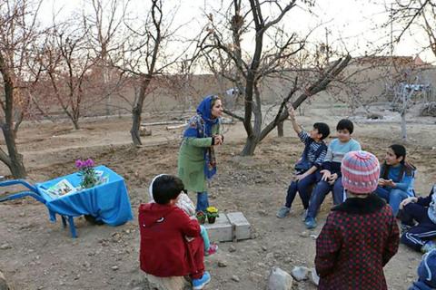 Geography graduate student Elham Nasr Azadani tells a story to students at the nature school about “Yalda Night.”