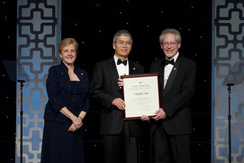 George A Olah Award recipient Chunshan Song (center) is presented his award by John Adams (right) and Bonnie A. Charpentier