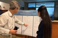Kenneth Davis, left, professor of atmospheric and climate science in the College of Earth and Mineral Sciences, discusses a potential link for future research with high school student Isadora Zuo at Penn State's EnvironMentors Research Symposium on April 26
