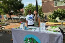 Jasmine Fields, left, engages with the public on local sustainability efforts during the Living in One Neighborhood (LION) Bash in 2024. Fields, a 2018 Penn State graduate in geosciences, is the sustainability program officer for the Borough of State College